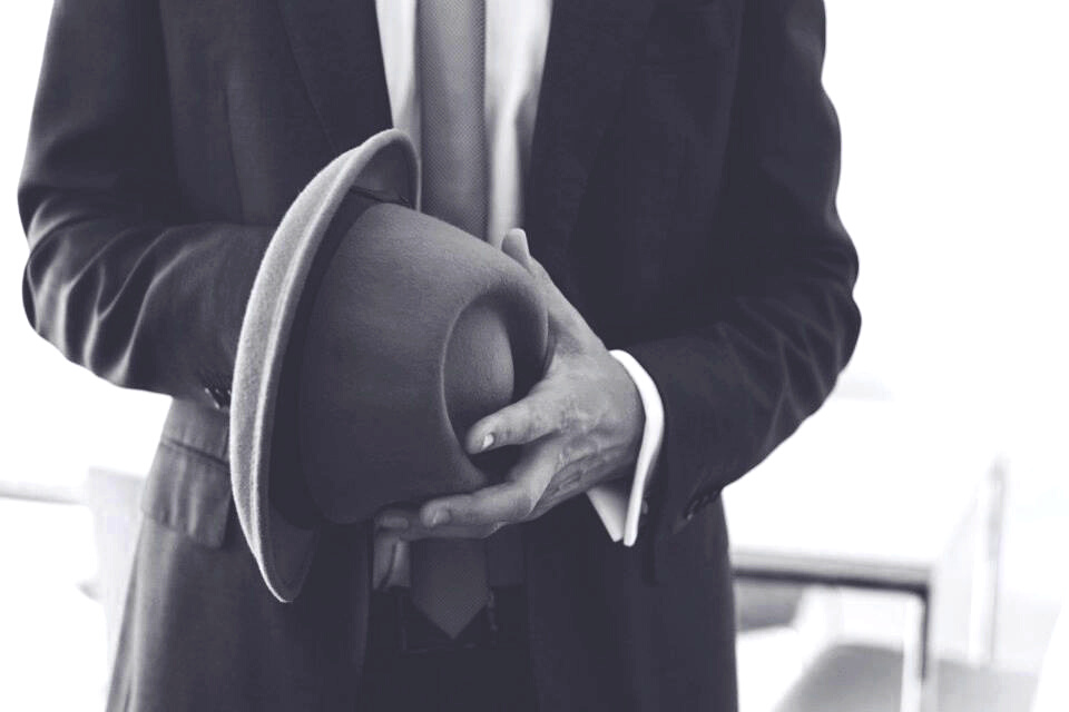 A hat in the hands of a man.